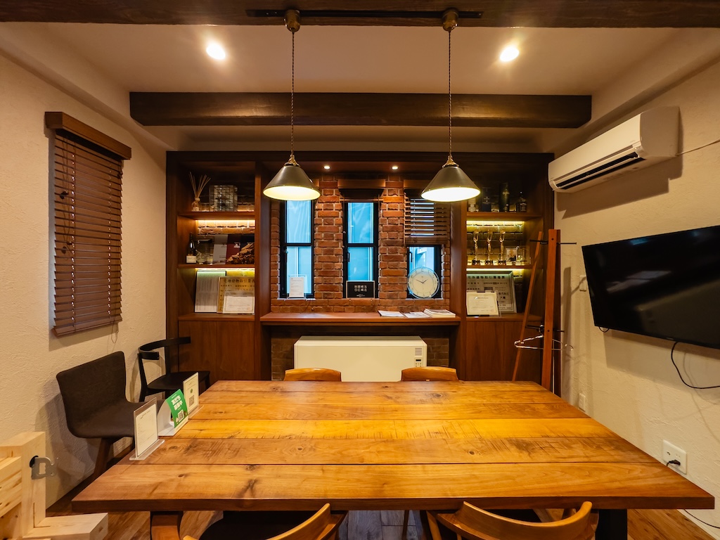 重厚な梁とレンガタイルの壁面が美しいインダストリアルな打ち合わせスペース